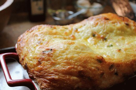 Fotografia lui Hashbrown under fondue de brânză